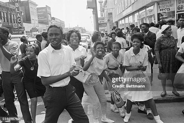 African American demonstrators, participating in a segregation protest taunt a policeman and a reporter in Birmingham, Alabama.