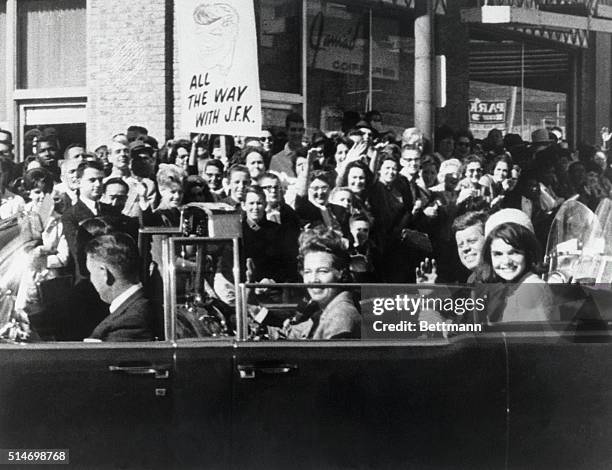 President Kennedy and wife Jackie ride in a motorcade among the crowds in Dallas on November 22, 1963. Moments later President Kennedy will be...