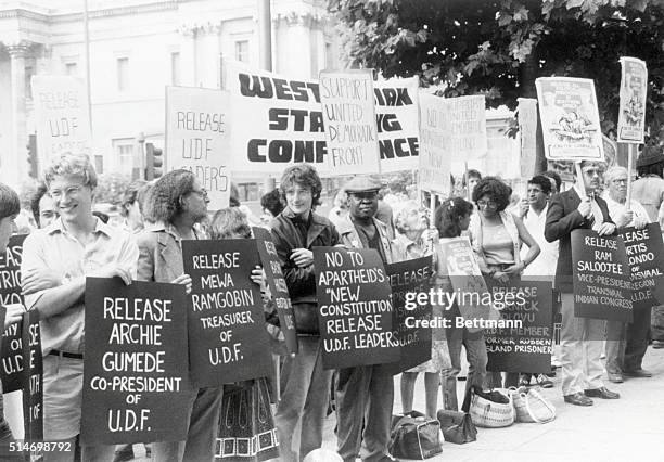 Demonstrators in London hold signs protesting the arrest of black leaders in South Africa. 1984.