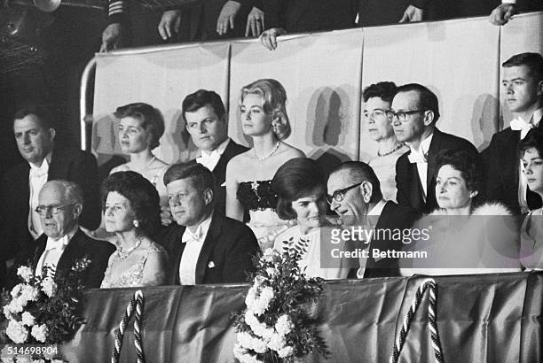 First Lady Jackie Kennedy speaks with Vice President Johnson in the presidential box during the inaugural ball. Also in the box are President...