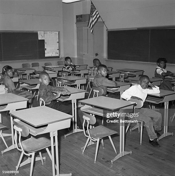 African American children sit at their desks in a classroom of Lincoln School. Only nine out of 20 students in this fourth-grade class showed up,...