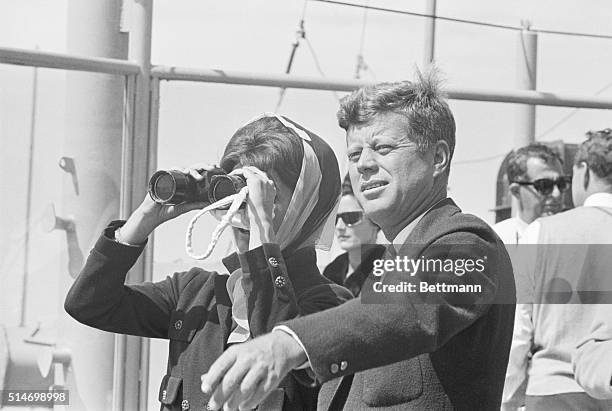 First Lady Jackie Kennedy watches Weatherly and Gretel, two boats in the America's Cup Races. The Kennedys watch the race from Naval destroyer USS...