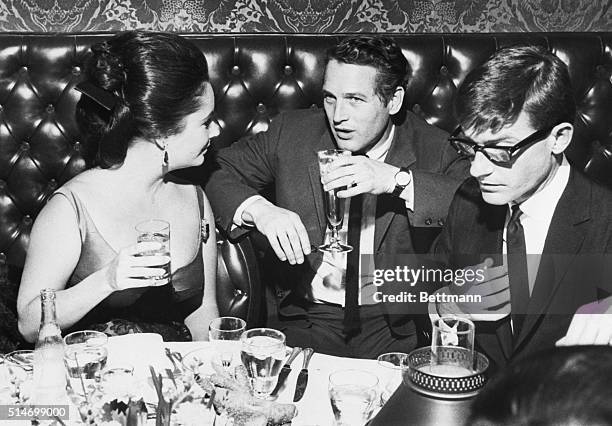 Former child star Roddy McDowell appears preoccupied with another matter as Liz taylor and Paul Newman talk shop.