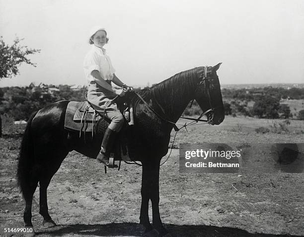 Lady Bird Johnson, First Lady, rides a horse on the Johnson family ranch in Texas on January 1, 1963.