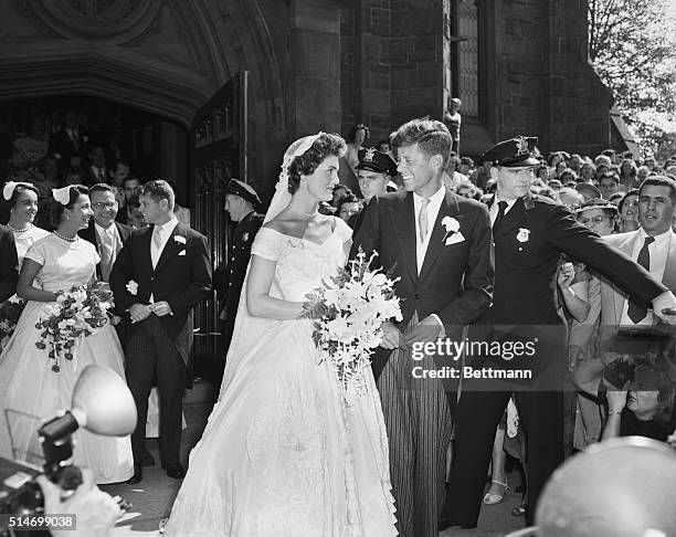 Senator John F. Kennedy and his bride, the former Jacqueline Lee Bouvier, leave a Newport, Rhode Island, church following their wedding ceremony. An...