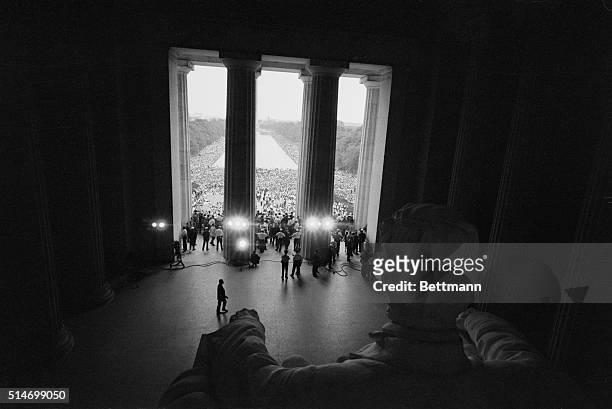 View, looking east from inside the Lincoln Memorial, of the crowd of Civil Rights activists during the March on Washington gather around the Lincoln...