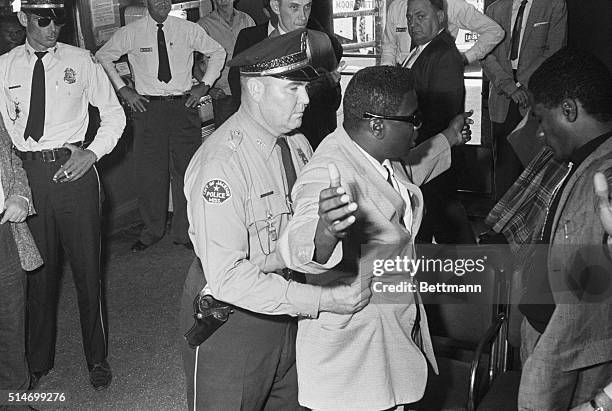 Freedom Rider is searched by a police officer in Jackson, Mississippi, after being charged with "breach of peace", 29th May 1961. 17 were jailed on...