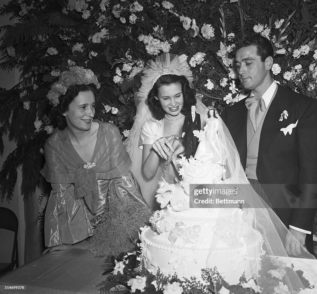 Gloria Vanderbilt And Groom Cut Cake
