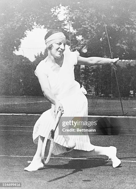 French tennis player Suzanne Lenglen returns a volley at Wimbledon.