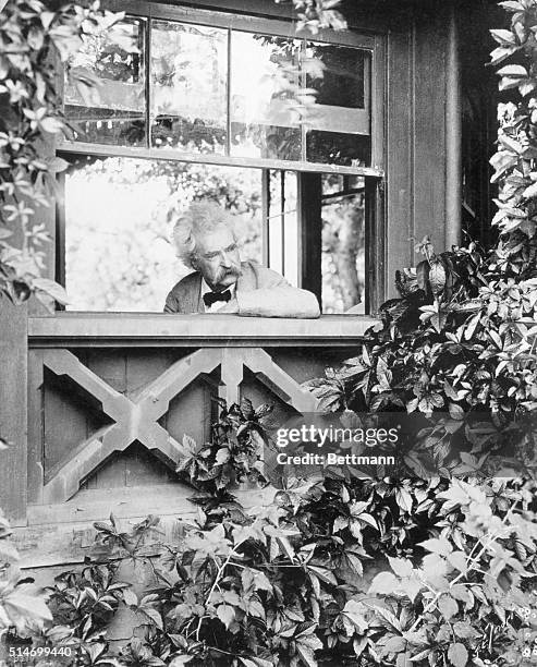 Elmira, NY: Mark Twain at his writer's desk looking out of the window.