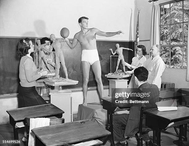 Actor Ronald Reagan poses for a sculpture class at the University of Southern California in 1940. He was chosen as an example of the ideal male...
