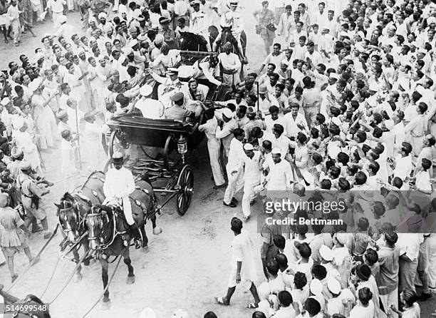 New Delhi, India: From a state coach drwn by six horses, Lord and Lady Louis Mountbatten, shake hands with the public upon arrival at Indian...
