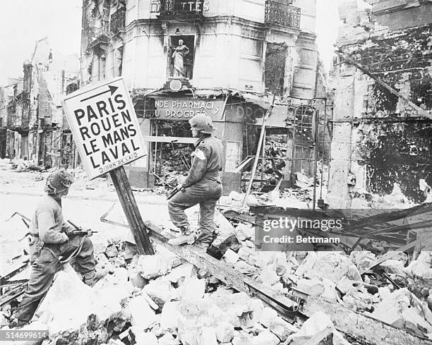 France; The arrow on this signboard in a wrecked street in Caen points towards Paris and other French towns. The bottom town may be named for the...