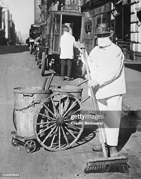New York Street cleaner wearing mask to check the spread of the influenza epidemic. "Better be ridiculous then dead" is the view of one official....