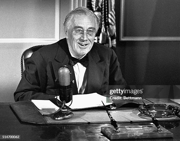 President Roosevelt is pictured at the microphone as he broadcast an appeal for greater than ever contributions to the National and Community War...