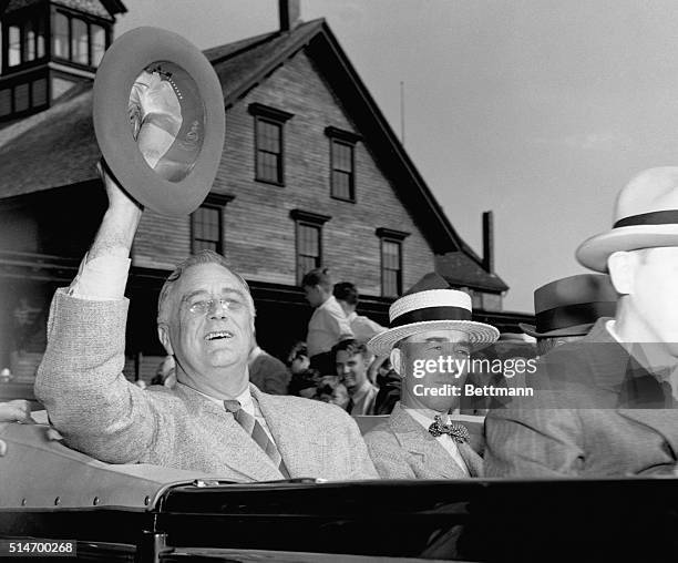 President Franklin D. Roosevelt waves his fedora in salute to Rockland crowds who greeted him as he landed after his momentous talks on the high seas...