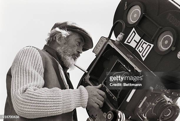 Rome, Italy: Director John Huston, bearded for his role as Noah, looks down on set of "The Bible," on location here. Photo shows Huston wearing a cap...