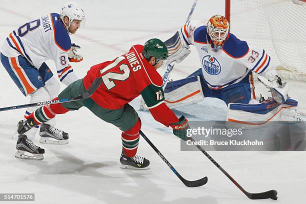 Griffin Reinhart and goalie Cam Talbot of the Edmonton Oilers defends against David Jones of the Minnesota Wild during the game on March 10, 2016 at...