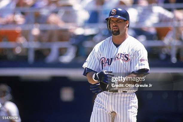 Ken Caminiti of the San Diego Padres looks on as he adjust his batting gloves during a game against the St. Louis Cardinals at Jack Murphy Stadium on...