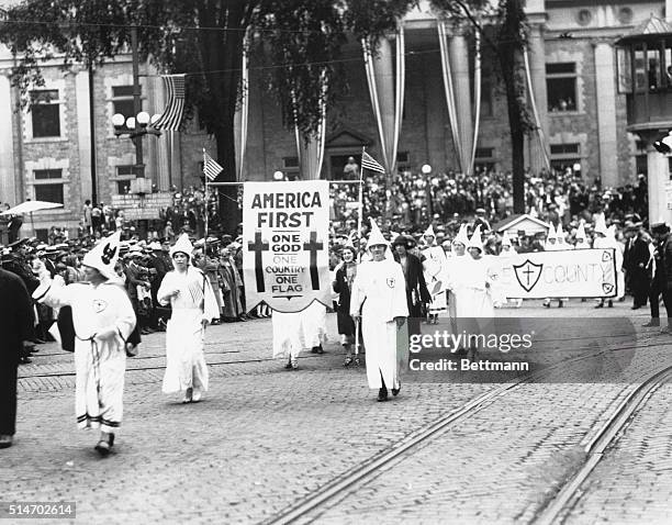 Binghamton, NY: Ku Klux Klan stages an 'America First' parade in Binghamton, NY. Photograph. 1920's.
