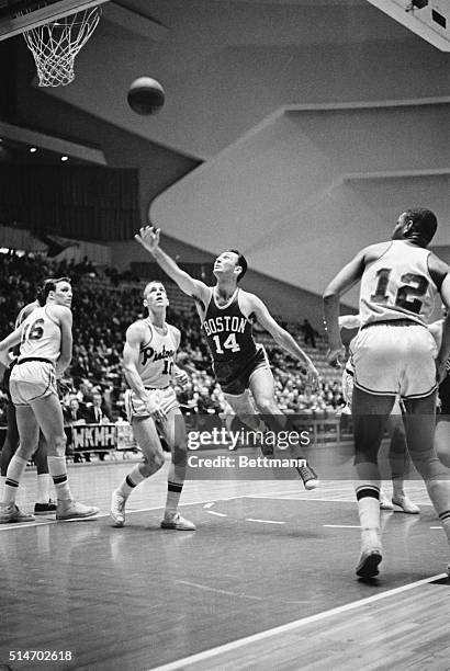 Boston Celtics player Bob Cousy shoots a lay-up in a 1963 game against the Detroit Pistons.