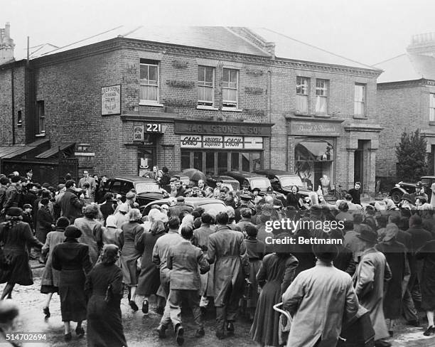 London, England: The crowd gathers around a car leaving the police station in suburban Putney, hoping for a glimpse of suspected sex slayer John R....