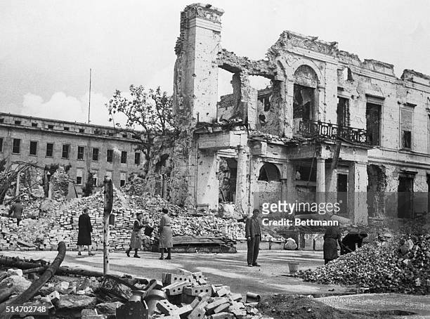 July 1945-Berlin, Germany: Germans clear rubble away from street front of Dr. Goebbels wrecked propaganda Ministry in Berlin. They are made to do...
