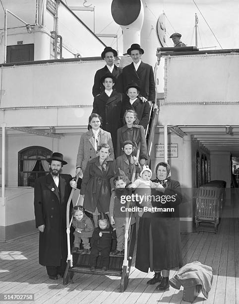 New York, NY: Rabbi User Weinberger, his wife, Fedora, and their 12 children, ranging in age from 7 months to 16 years, arrive in New York aboard the...