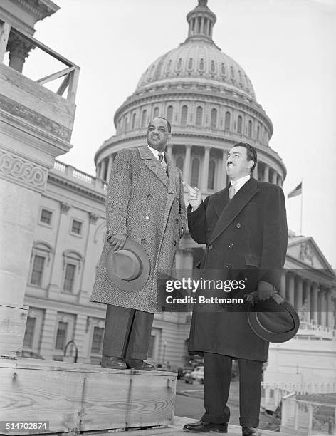 Washington, DC: Negro Congressmen. Representative William Dawson and Representative Adam Clayton Powell , Negro congressmen, pause to look at...