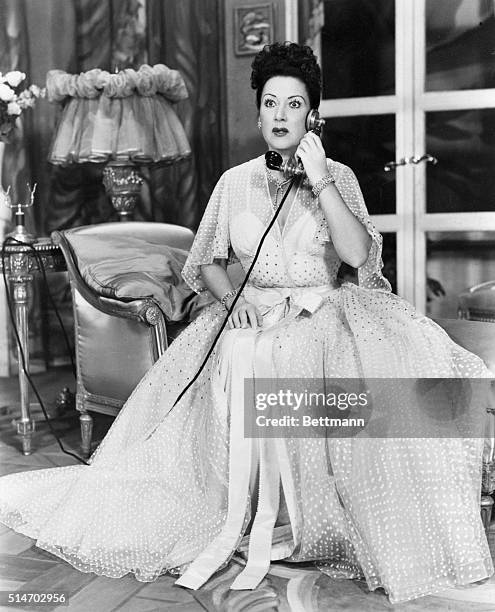 New York, NY: Ethel Merman, star of the musical "Call Me madame," gets unsettling tidings over a stage telephone at the Imperial Theater, where the...