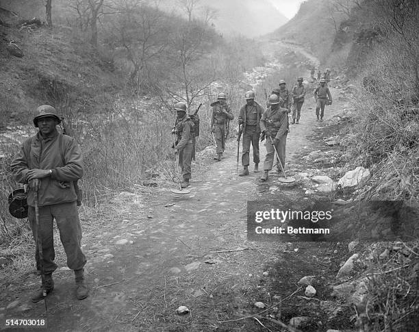 Korea: Members of a U.S. Combat engineers battalion sweep a winding trail for mines and booby traps in a rugged mountain area on the central front in...