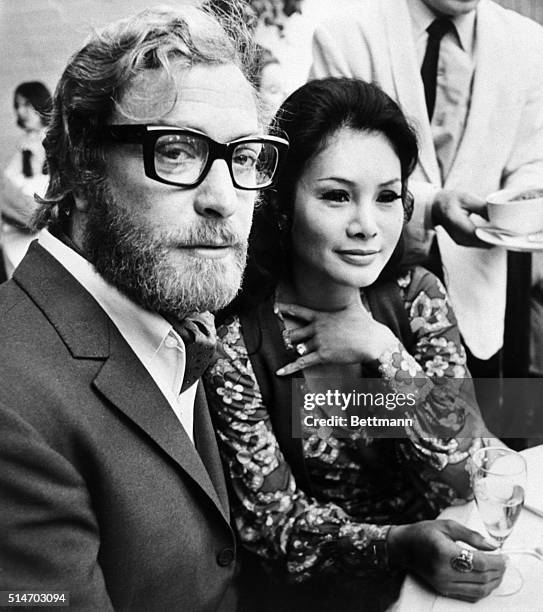 London: A bearded Michael Caine, actor, celebrates with friend Minda Faliciano at a recent reception at the Arathusa Restaurant in London. The...