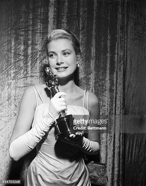 Smiling Grace Kelly clutches her Oscar after winning the coveted Academy Award March 30th as "Best Actress" of 1954. Miss Kelly won for her role in...
