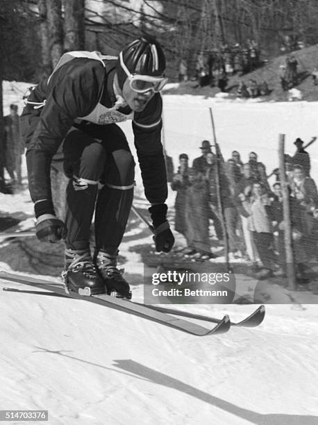 Cortina, Italy: Toni Sailer of Austria, swoops downhill to complete the greatest ski performance in Olympic history by winning his third gold metal...