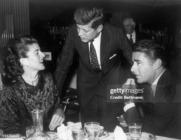 Los Angeles, CA: It's time for a family reunion as Sen. John Kennedy stops at the table to chat with his sister, Patricia, in Los Angeles' press...