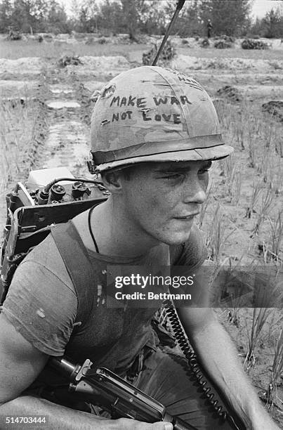 Da Nang, South Vietnam: Marine Cpl. Michael Wynn of Columbus, Ohio, seems to be trying to get a message across with a takeoff of the hippie slogan...