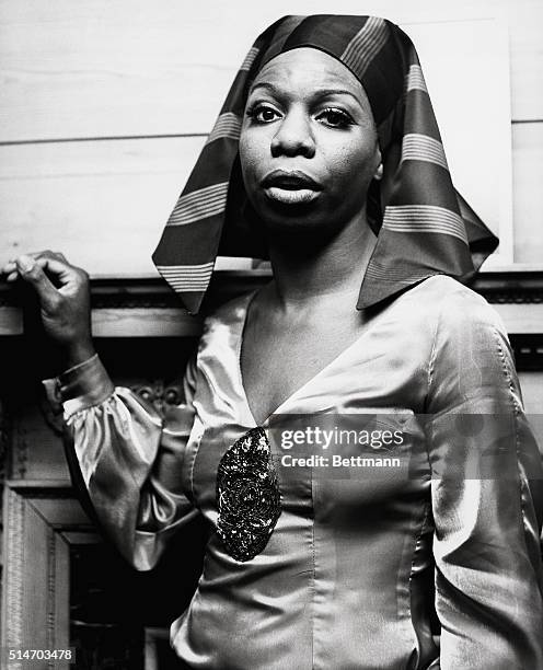 Singer Nina Simone wears a "pharaoh-style" scarf and silk blouse.