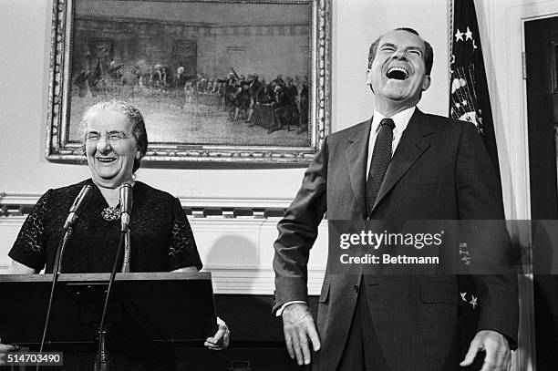 Israeli Prime Minister Golda Meir and US President Richard Nixon break into laughter just before making their final statements in the Roosevelt Room...