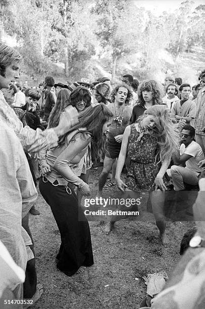 Los Angeles: A couple of girls do a dance at a "love-in" held at Elysian Park 9/22. Outbreaks of violence were reported as a crowd of nearly 7,000...