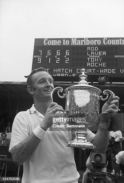 Forest Hills, NY: Rod Laver of Australia flashes a big grin as he holds the winner's trophy at the US Open Tennis Championships Sept. 8th. Scoreboard...