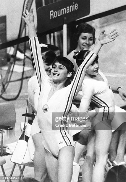 Romanian gymnast Nadia Comaneci celebrates after scoring a perfect 10.00 in competition at the 1976 Summer Olympics in Montreal, Canada.