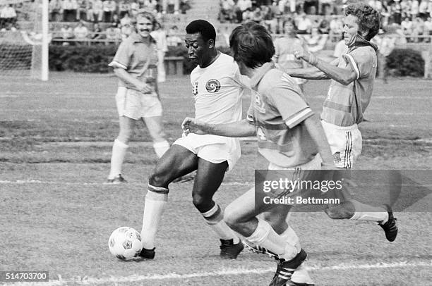 Soccer superstar Pele runs with the ball during his first game for the New York Cosmos against the Dallas Tornadoes.