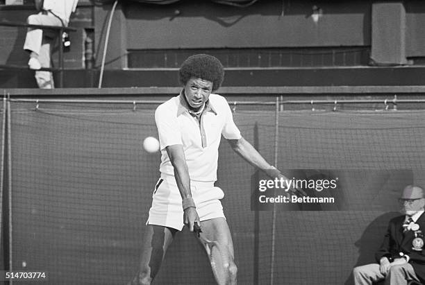 Tennis player Arthur Ashe swings at the ball during his win in the quarter-finals of the 1975 Wimbledon tournament.