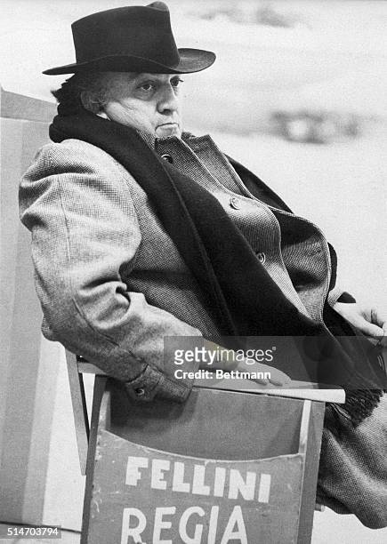 Federico Fellini rests in a chair while filming Amarcord in Rome.