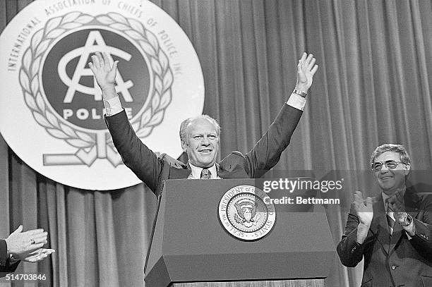 Miami Beach, FLA: President Ford smiles as he acknowledges the reception given to him at the convention of the International Association of Chiefs of...