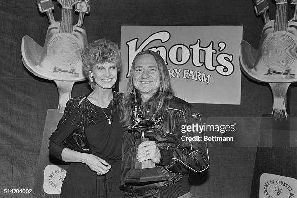 Willie Nelson and his wife Connie smile with happiness and pride after winning an award for Album of the Year and Single Record of the Year at the...