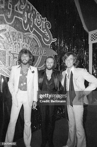 New York: Collectively known as the BEe Gees' brothers Barry, Maurice, and Robin Gibb gather inder sign heralding their new movie during party at...