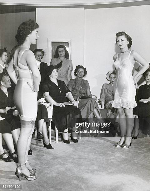 New York City: Two figure molding costumes are modeled for buyers visiting the Bien Jolie Salon. At left is a two piece bra and girdle combination....