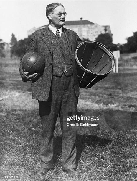 The inventor of basketball, Dr. James Naismith, stands in a field carrying a ball and a basket.