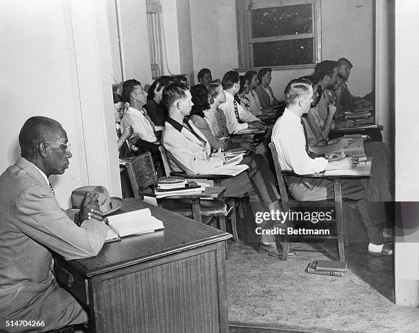 George W. McLaurin, a 54 year old African American, sits in an anteroom, apart from the other students, as he attends class at the University of...